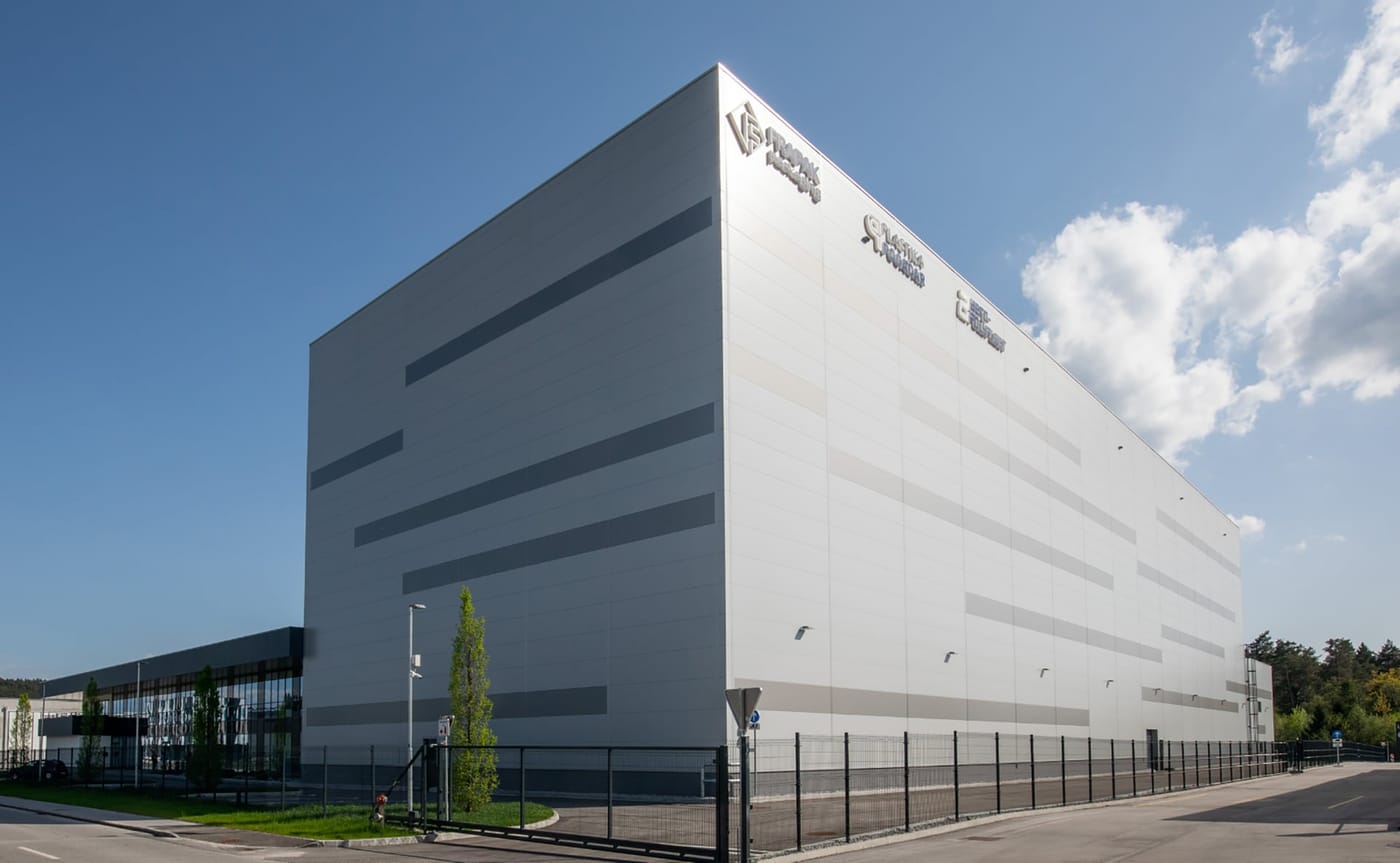 The white FlexPET production facility in Slovenia under a blue sky