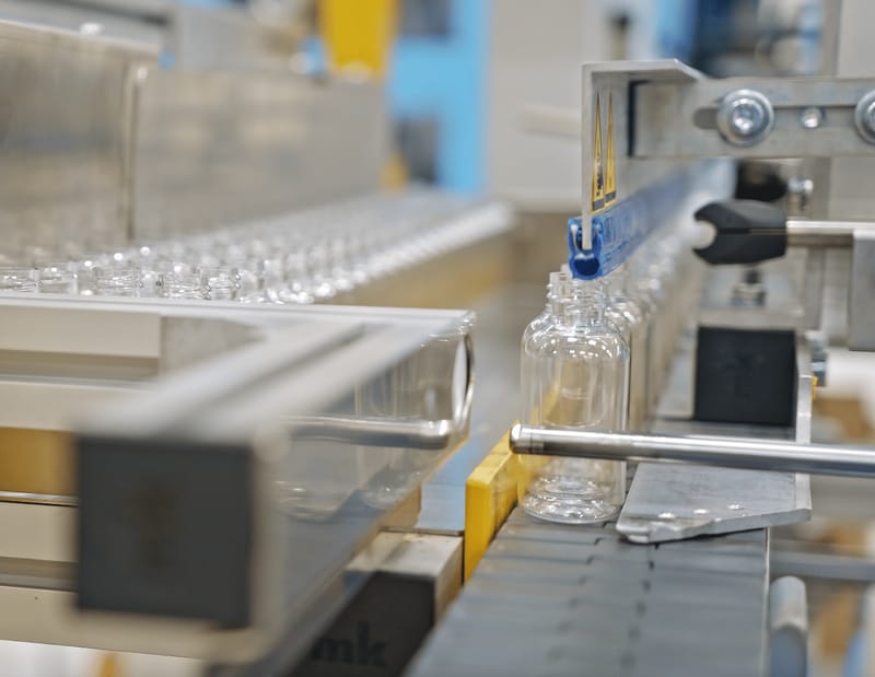 Clear PET bottles on a filling line in the factory